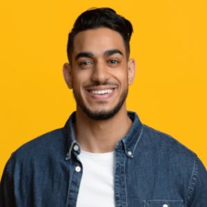 Newgenhost Social Media Promotion 3 Newgenhost-Smiling Middle Eastern Man In Casual With Laptop Y9Ey47V